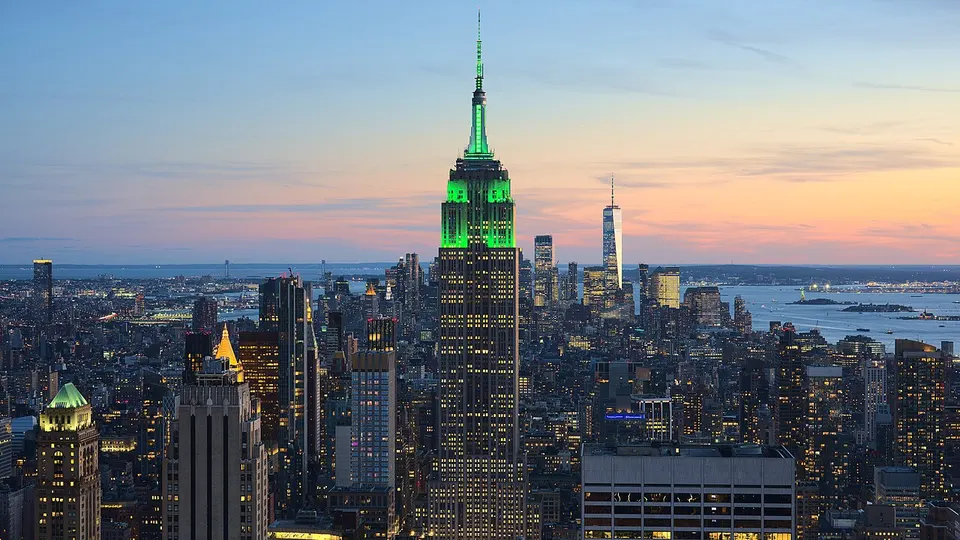 New York: View of the Empire State Building in New York City from the Top of the Rock at 30 Rockefeller Plaza during sunset. The tower was illuminated
